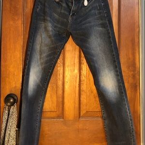 dark blue jeans with “faded” knees